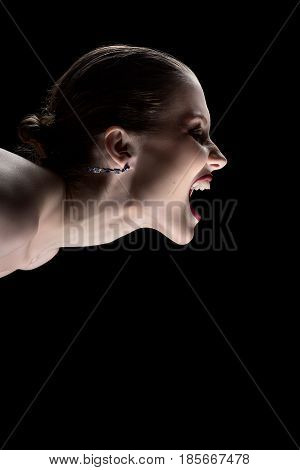 angry nude girl screaming on black background