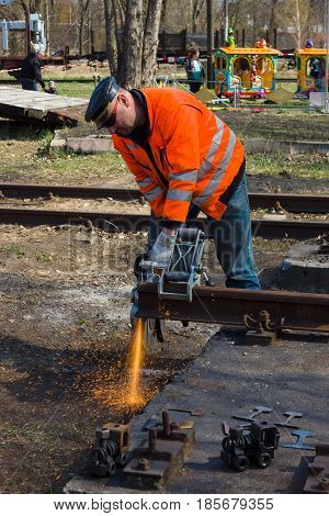 BERLIN - APRIL 21: Working Deutsche Bahn demonstrates working with cutting machine. Spring Festival Exhibition in the Rail yard Schoeneweide April 21 2013 in Berlin Germany