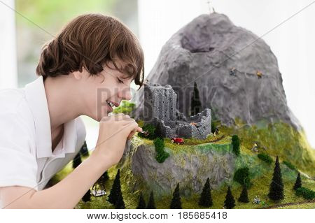 School Student Working On Model Building Project