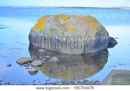 rock reflecting in calm lake landscape, sweden