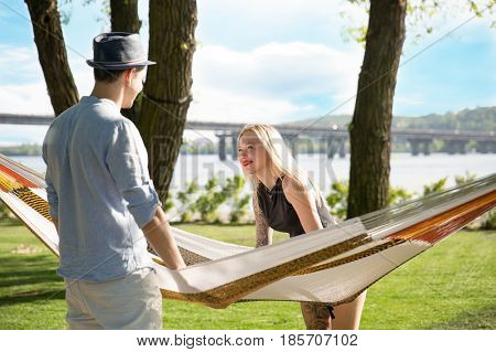 Picture of romantic couple in hammock look at each other
