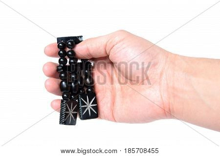 Rosary in hand on a white background isolated.