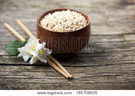Rice and jasmine flower onrustic wooden table