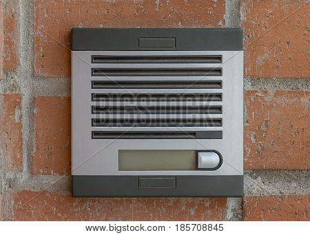 image of intercom on the brick wall background