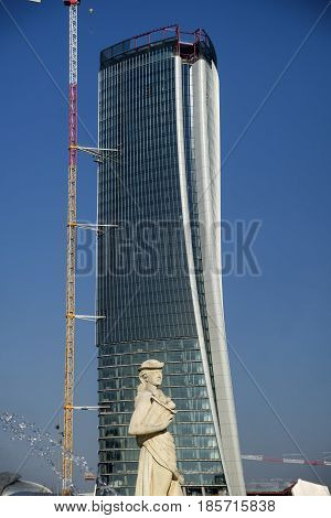 MILAN, ITALY - JANUARY 3, 2017: Milan (Lombardy Italy): the new Generali building under construction seen from the Giulio Cesare square with a statue of the fountain