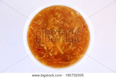 Chinese Hot and Sour Soup in a foam container. room for your text
