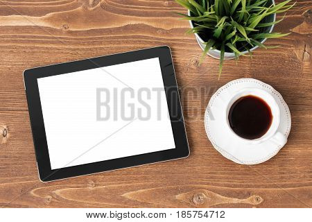 Tablet computer and coffie on wooden background