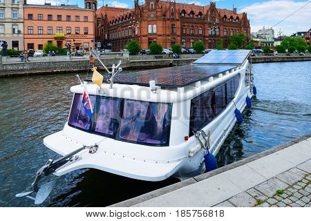 Bydgoszcz, Poland - May 8, 2016; Old Town And Tourist Boat - Solar Water Bus On Brda River