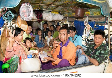 MINGUN, MYANMAR-MARCH 6, 2017: Burmese people on the light trucks in Mingun on March 6, 2017, Myanmar.