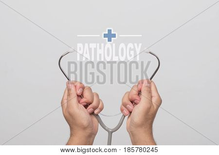 Hands holding a stethoscope and word 