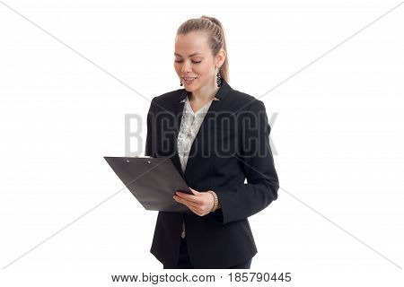 charming young business Lady in black suit looks at Tablet isolated on white background