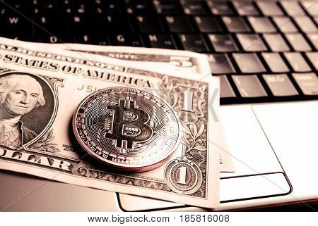 Bitcoin On Dollar Bill Over Laptop