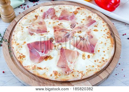 italian Pizza Prosciutto di Parma on wooden table