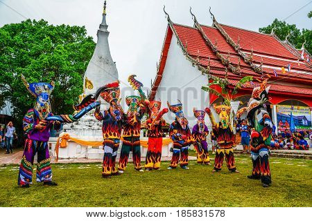 LOEI THAILAND - JUNE 27, 2015: Thai northeastern traditional Phi Ta Khon ghost mask dancer with wooden fake penis in Phi Ta Khon festival parade in Dansai of Loei, Thailand.