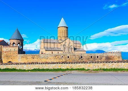 Panorama view of Alaverdi orthodox monastery in Kakhetia region in Georgia and snow peaks of Caucasus mountains