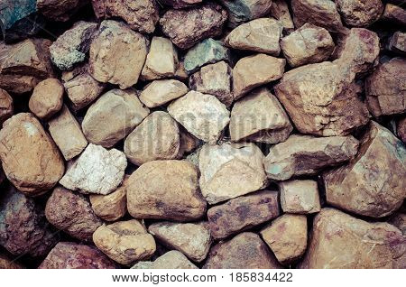 The background of the stone wall is strong brown.