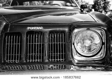 PAAREN IM GLIEN GERMANY - MAY 19: Headlamp Mid-size car Pontiac Grand Am (black and white) The oldtimer show in MAFZ May 19 2013 in Paaren im Glien Germany