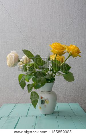 Rose Placed On The Desk In Blue Background