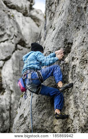 Podlesice Poland april 29 2017: Young male climber leading a route on a rock. Jura krakowska czestochowska. Poland