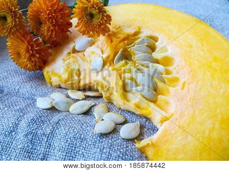 Pieces of cut pumpkin with seeds on the table.