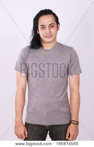 Photo image of an Asian Model smiling and showing blank grey T-Shirt front view shirt template
