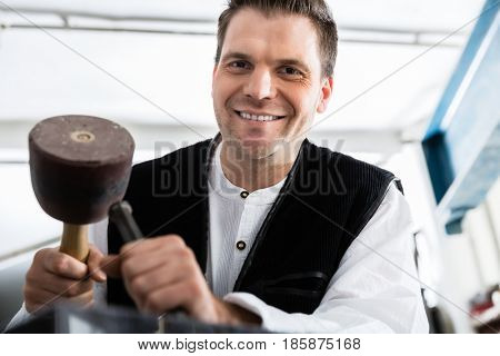 Stonemason working at marble pillar 