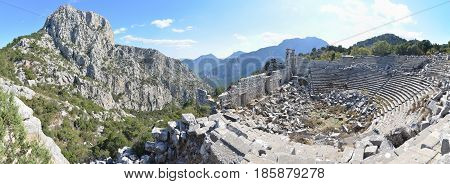 Antalya, Turkey - October 24, 203: Panoramic photo of amphitheater of Termessos Antique City in Antalya, on bright blue sky background
