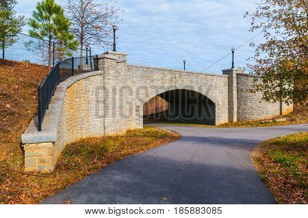 The Piedmont Park Trail and the stone bridge on the Evelyn St NE in autumn day Atlanta USA