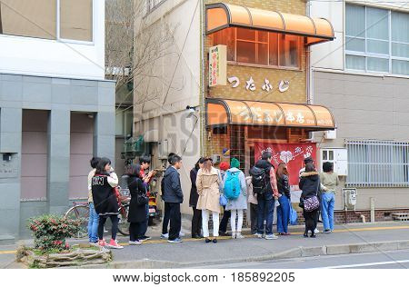 HIROSHIMA JAPAN - MARCH 18, 2017: Unidentified people queue at famous Tutafuji ramen noodle shop. Onomichi is famous for noodle calf Onomichi ramen.