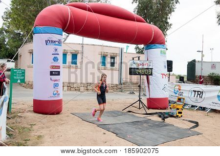 Nahariyya Israel - May 06 2017 : Participant of the annual triathlon finishes in the race in Ahziv near the town of Nahariya