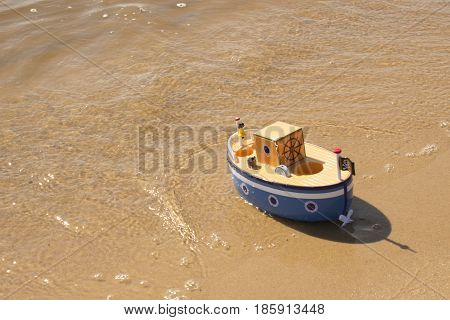 Toy ship floats in water. Returned to the shore
