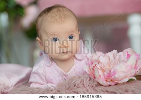 Portrait of adorable baby girl in pink dress.