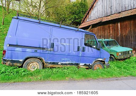 Dolni Dobrouc The Czech Republic - April 30 2017: Old ruined cars. Ruined delivery van and car. Rusty van and car covered with moss
