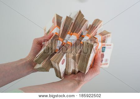 female hand holding of many Russian banknotes