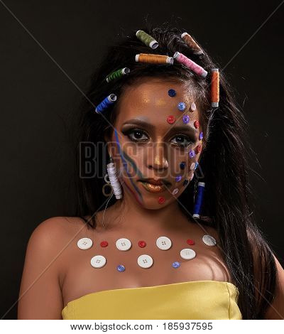 Young brunette with buttons on the front and papiotes in hair with yellow dress