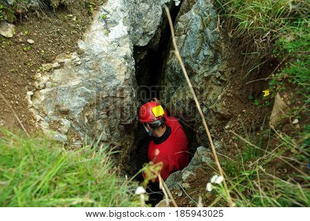 Caver Descends In A Cave