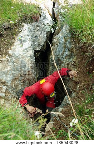 Caver Descends In A Cave