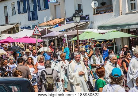 Saintes-Maries-de-la-Mer, France - May 25, 2015. Religious holiday in honor of the Holy Maries in Provence. The concept of ethnographic tourism. Participants of a procession bear banners