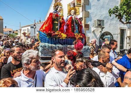 Saintes-Maries-de-la-Mer, France - May 25, 2015.  The concept of ethnographic tourism. The crowd is accompanied by two statues of the Holy Maries to the seashore. Religious feast 
