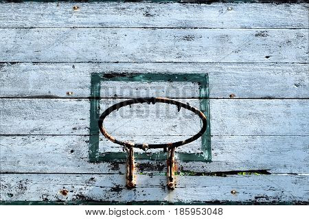Close up old basketball hoop with blue sky background.