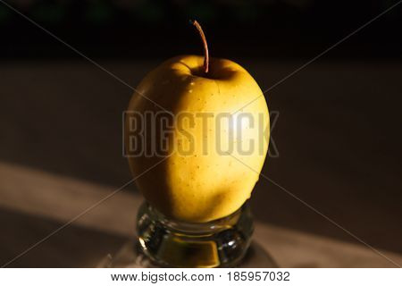 Yellow apples in a vase on a dark background. Beautiful apple.