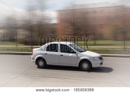 white minicar on city streets, high speed