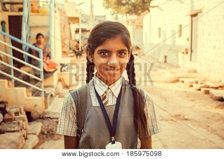 BADAMI, INDIA - FEB 8, 2017: Unidentified Indian schoolgirl having fun outdoor in small asian village on February 8, 2017. Population of Karnataka state is 62000000 people