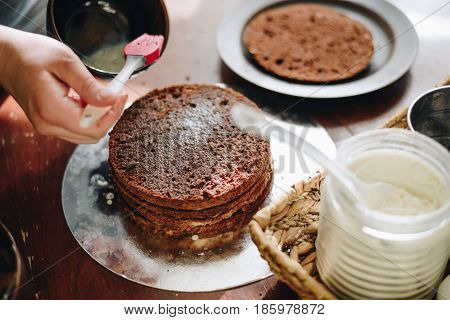 woman hands makeing cake on wooden background