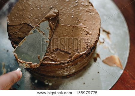 woman hands makeing cake on wooden background