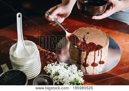 woman hands makeing cake on wooden background