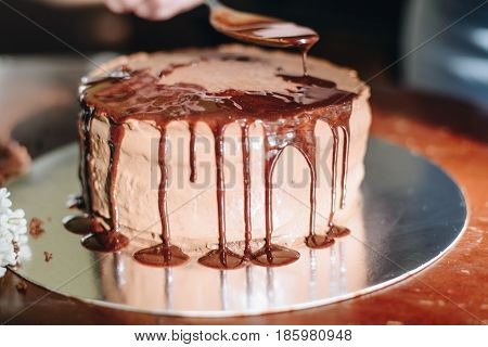 woman hands makeing cake on wooden background