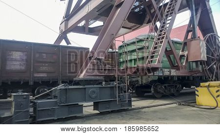 Loaded Freight Cars In The Port. Passage Of Cars Under The Tower