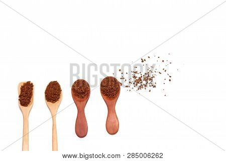 Instant Coffee Powder In A Row Of Wooden Spoons And The Ground On White Isolated Background