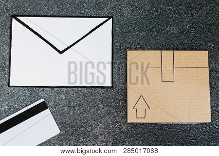 Cardboard Parcel With Email Envelope And Payment Card On Concrete Desk, Concept Of Shipping And Trac